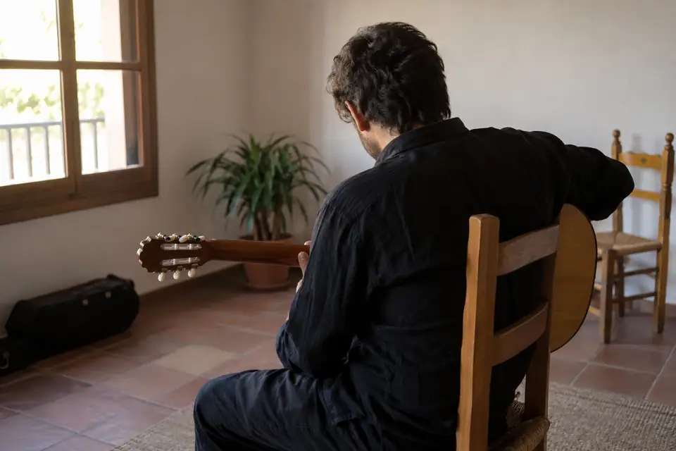 Een flamencogitarist van achteren